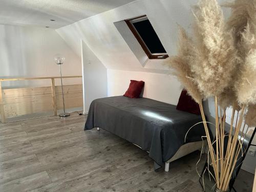 a bedroom with a bed and a skylight at Stawalters in Kirrwiller