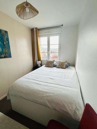 a bedroom with a large white bed with a window at Downtown High Standing Duplex - "CENTRUM" in Épernay