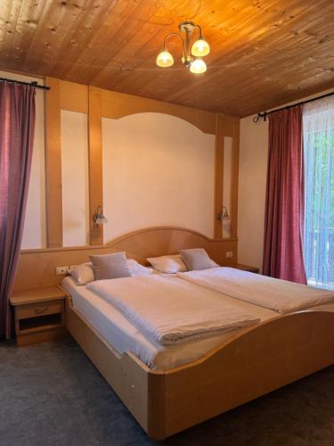 a bedroom with a large bed in a room at Garni Rika in Parcines