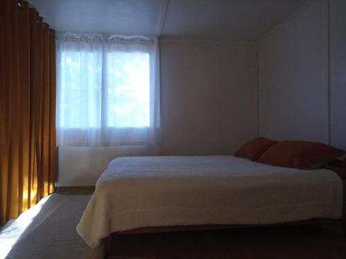 a bedroom with a large bed and a window at Peace House in Esztergom
