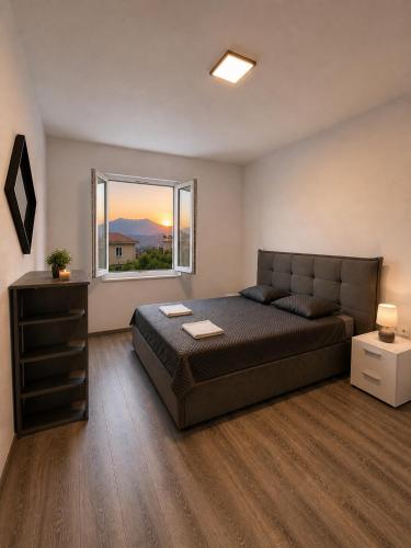 a bedroom with a large bed and a window at Centrium Makarska in Makarska