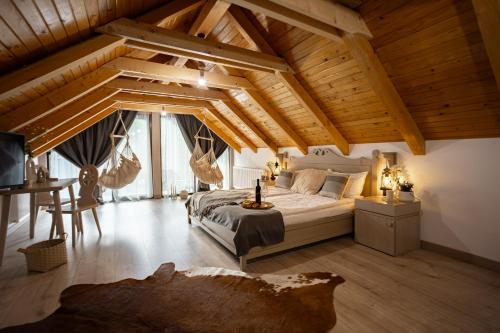 a bedroom with a bed and a desk in a room at Pensiunea Mama Cozonacilor in Bran