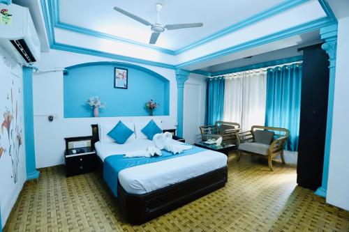 a blue bedroom with a bed with an elephant on it at Kalpataru Hometel in Mumbai