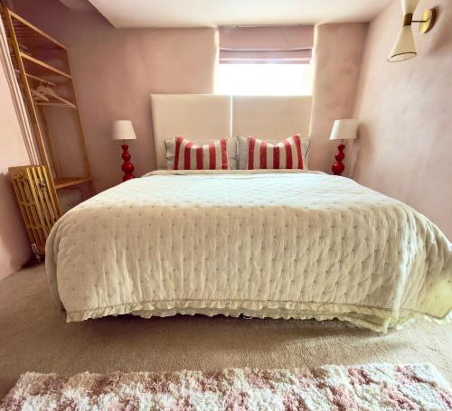 a bedroom with a large white bed with a window at The Old Feed Store in Okehampton
