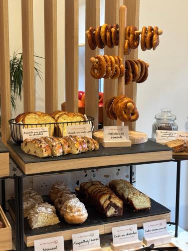 a display case with different types of bread and pastries at Hôtel De L'Ill in Strasbourg