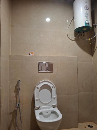 a bathroom with a toilet with the seat up at Arunachal residency in Dibrugarh