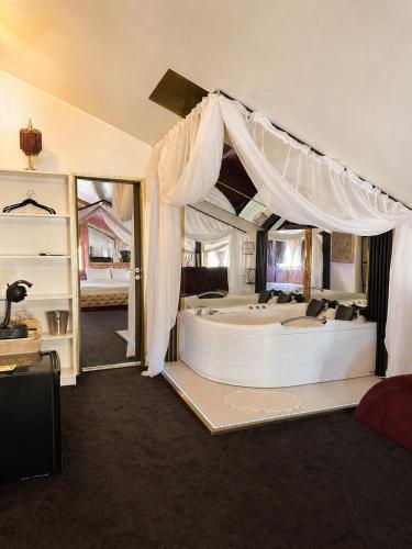 a large bedroom with a large bed with a canopy at Hotel Boutique18plus - Adults Only in Mamaia Sat/Năvodari