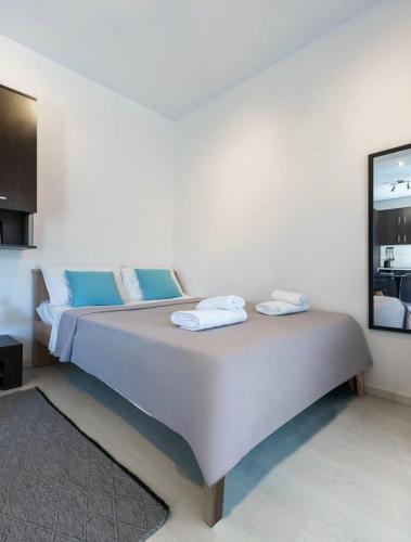 a bedroom with a bed with two towels on it at Elysian Hightower in Thessaloniki
