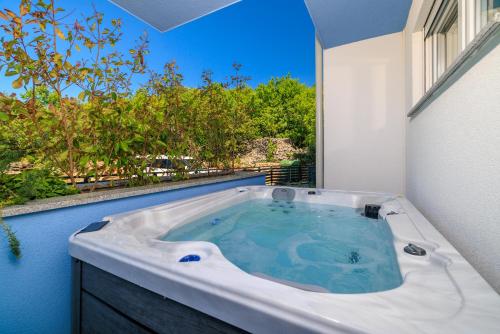a jacuzzi tub in a room with a window at Schmidt mali in Dramalj