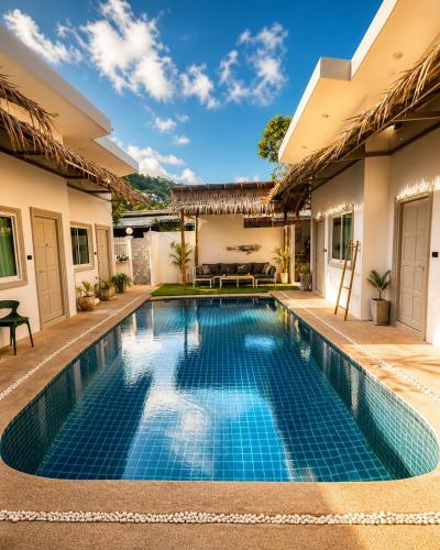 a swimming pool in the backyard of a house at jungle pad accomodation in Rawai Beach