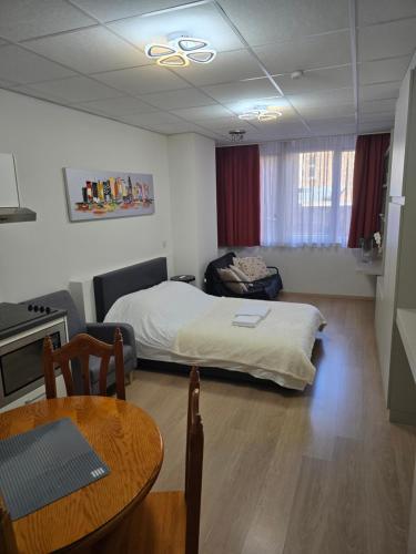 a bedroom with a bed and a table in a room at Brussels square in Brussels