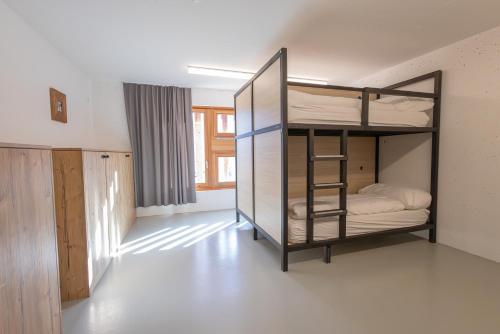 a room with a bunk bed with a ladder at Vercorin group lodge 18 people in Chalais