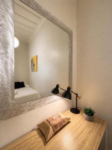 a bedroom with a large mirror on the wall at CitiRooms Auckland in Auckland