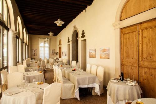 a dining room with white tables and white chairs at Hotel Villa Ca' Sette in Bassano del Grappa