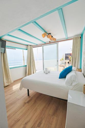 a bedroom with a large bed with a large window at Respirar in Peniscola