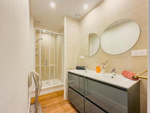 a bathroom with a sink and a mirror at Chic Bastide in Carcassonne