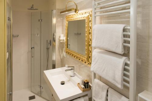 a bathroom with a sink and a shower and a mirror at Locanda Ca' Zose in Venice