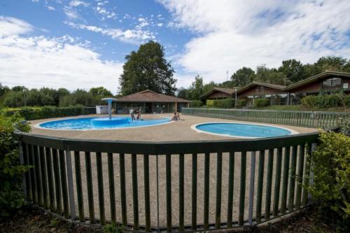 a pool with a fence around it at ZEcamping 4 pet friendly piscine couverte et parcours Fitness in Pressignac