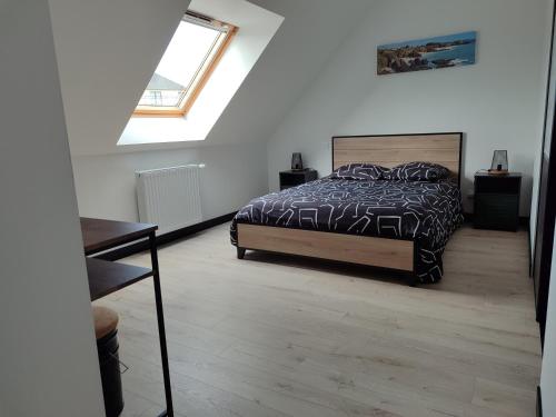 a bedroom with a bed and a window at Chez Audrey et Christophe in Saint-Pol-de-Léon