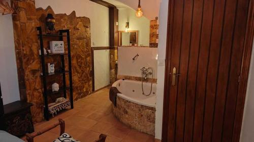 a bathroom with a bath tub in a room at El callejón del Santo in Ubrique