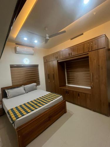 a bedroom with a large bed and a window at Manasam Homes Near To IIM & NIT - kOZHIKODE in Kunnamangalam