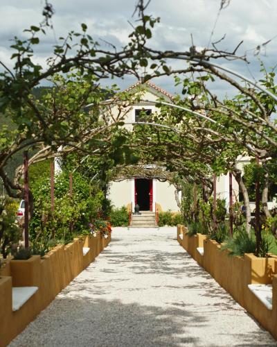 an archway in a garden with plants at Quinta das Riquezas in Dornes