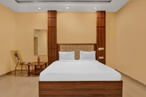 a bedroom with a large bed and a chair at Amba heritage house in Prayagraj