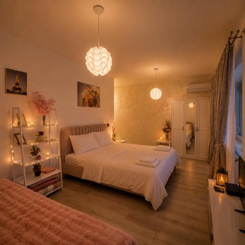 a bedroom with a large white bed and two lights at CENTRAL Apartment 84- free parking- spital Recuperare in Iaşi