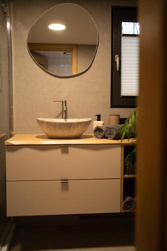 a bathroom with a sink and a mirror at Okno na Beskidy -domek NIEBO z balią , sauną i niesamowitym widokiem na góry in Maków Podhalański