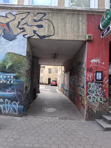 a tunnel with graffiti on the side of a building at Paulibude in Hamburg