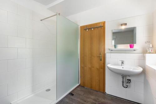 a white bathroom with a sink and a shower at Ferienwohnung Im Tal Olsberg in Olsberg
