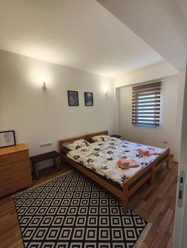 a bedroom with a bed and a rug at Sunny Pine Apartment Mavrovo in Mavrovo