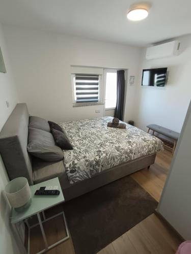 a small bedroom with a bed and a couch at Sleepover Room K&M in Novoselec
