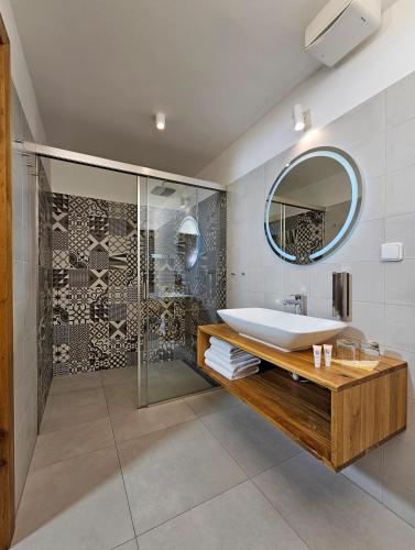 a bathroom with a tub and a sink and a mirror at Hotel U Feldů in Klimkovice