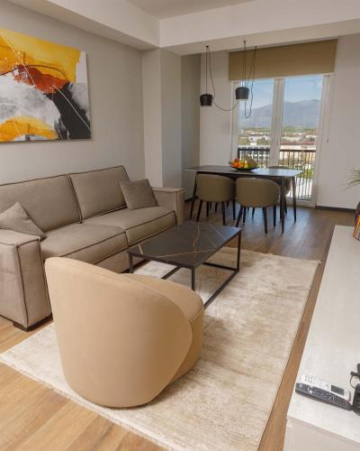 a living room with a couch and a table at Hotel Cube 55 - Business Suites in Skopje