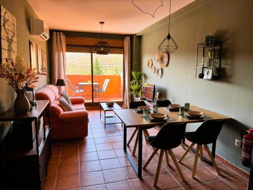 a living room with a table and chairs at El Mirador de Adrial in Ladrillar