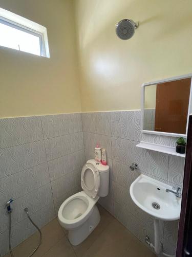 a bathroom with a toilet and a sink at dayah homestay in Siputih