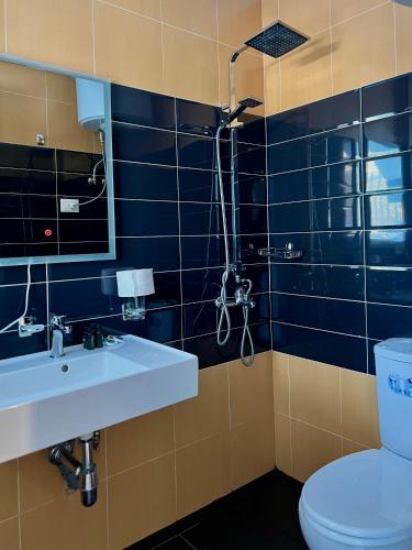 a bathroom with a sink and a toilet at Beach Studio Apartment in Dhërmi