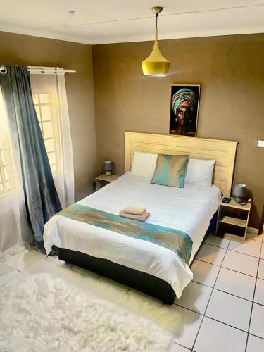 a bedroom with a large bed in a room at Maun East Gate Guesthouse in Maun