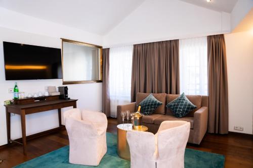 a living room with a couch and a table at Luxury Boutique Hotel Iris Porsche in Mondsee