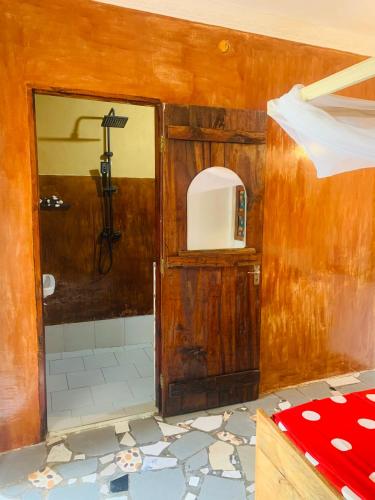a bathroom with a shower and a toilet in a room at Paje lounge in Paje