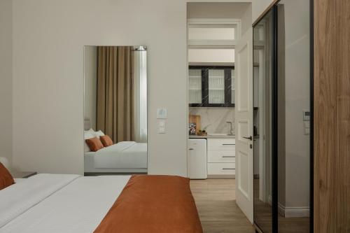 a hotel room with a bed and a bathroom at Oikia Classic House in Old Town Kavala in Kavála