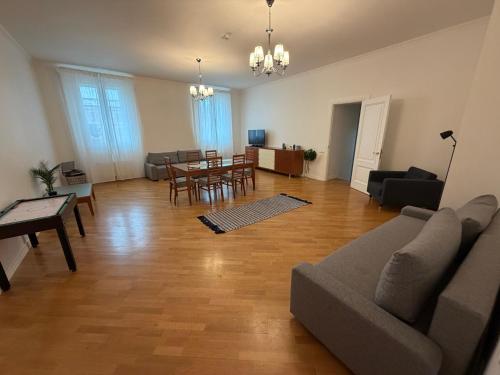 a living room with a couch and a table at Spacious 2 bedroom apartment, Old Town Riga in Riga