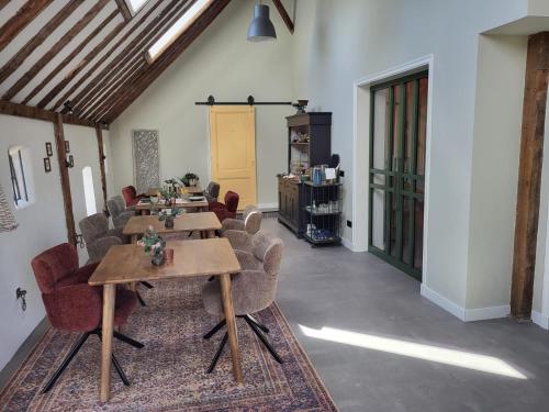 a room with tables and chairs in a building at Noardlik B&B in Birdaard