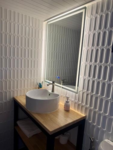 a bathroom with a sink and a mirror at Duplex House in Chaloklum