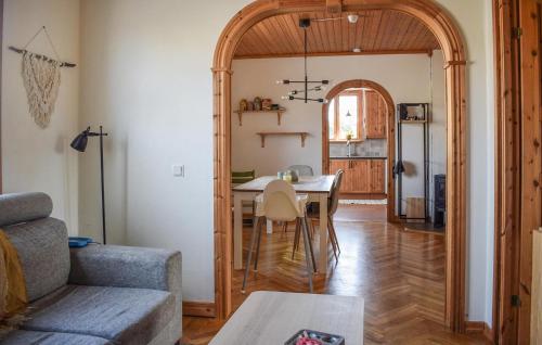 a living room with a dining room table and an archway at Awesome Home In Sölvesborg With Wifi in Sölvesborg