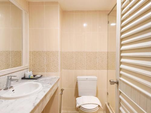 a bathroom with a toilet and a sink at BP Chiangmai City Hotel in Chiang Mai