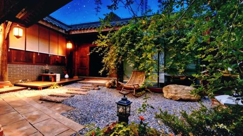 a courtyard of a house with a bench and a table at Nan Court - Nanyuan,Leshan in Leshan