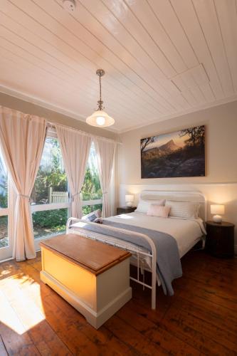 a bedroom with a bed and a large window at Dunkeld Secret Garden in Dunkeld