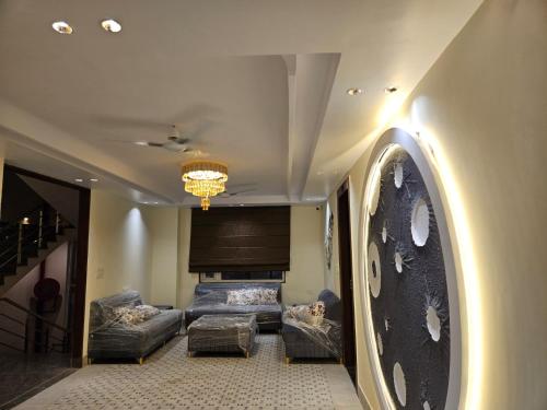 a living room with couches and a piano at Hotel Gangotri Suites in Haridwār